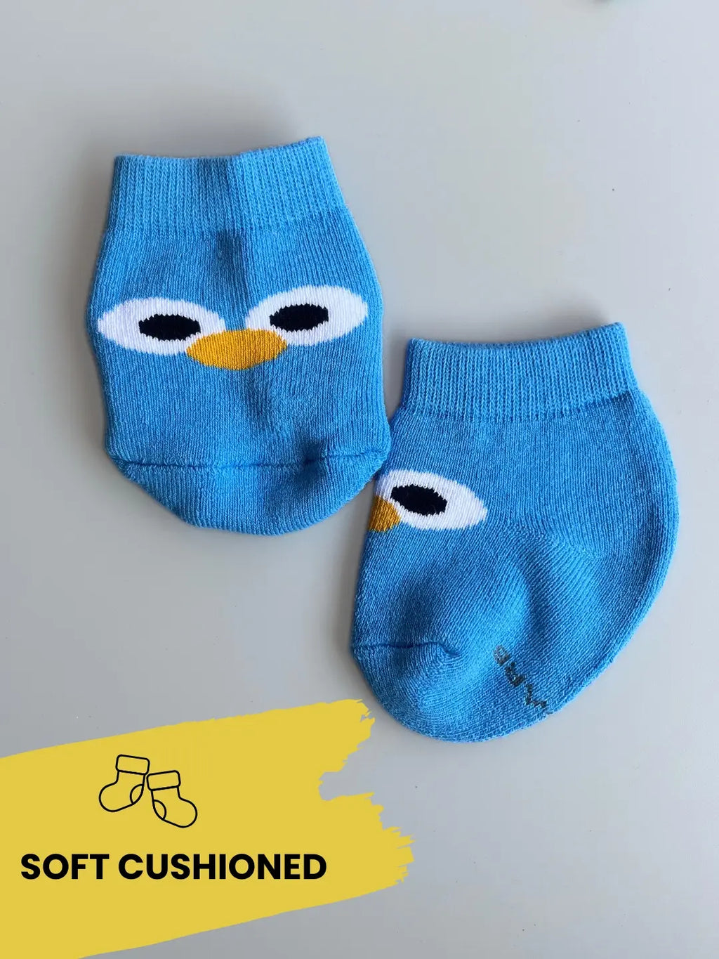 Air Garb brand baby combo socks for infants; a 6-pair set of soft cotton socks featuring pineapple, watermelon, cherry, and cute character face designs in vibrant colors like yellow, red, and blue.
